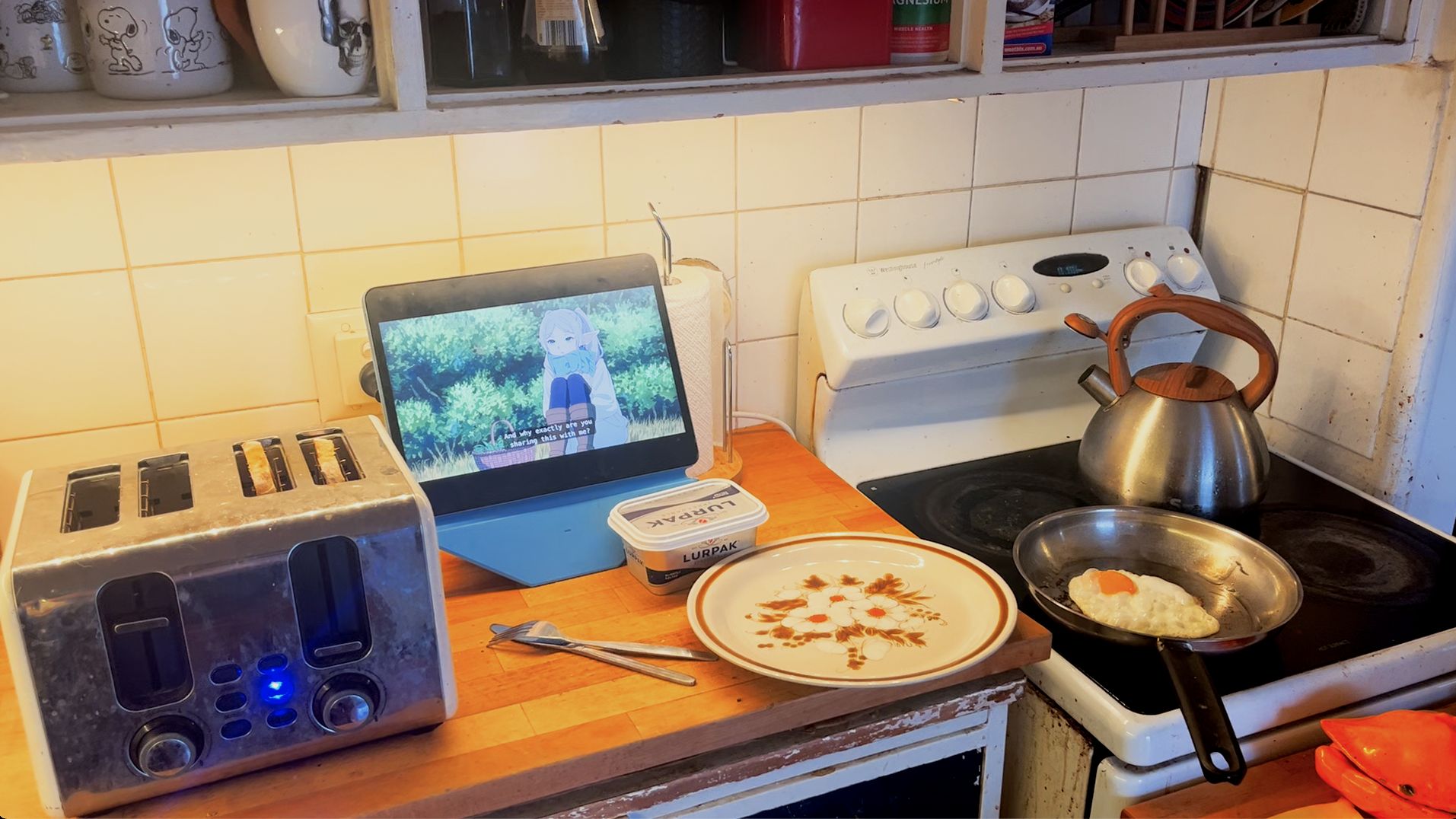 Kitchen bench with a tablet playing Frieren